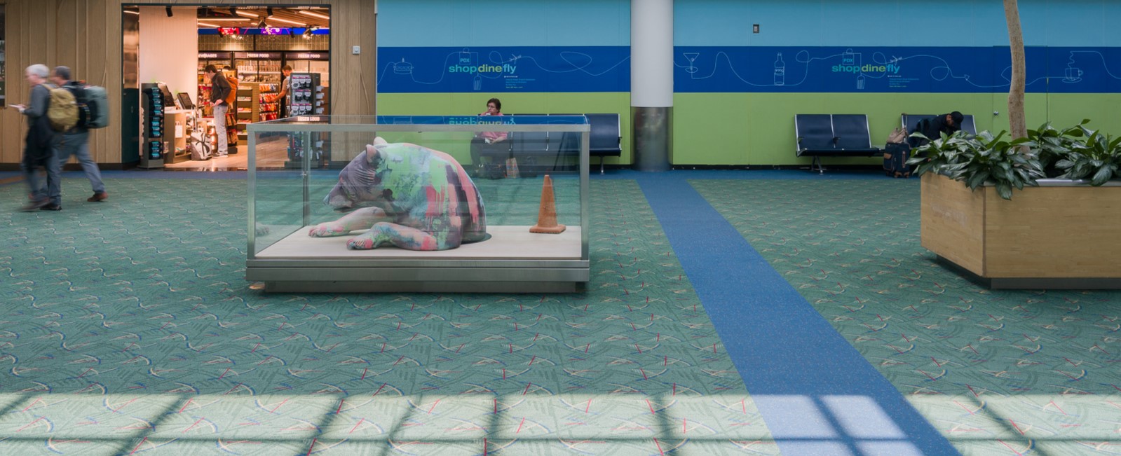 #slidecaption1 A Colorful Bear Emerges from Hibernation in Concourse D